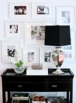 Black Table with White Frames and Table Lamp